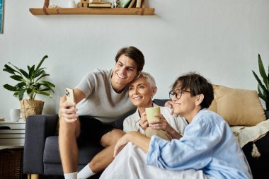 A joyful moment shared between lesbian parents and their adult son, celebrating love and togetherness. clipart