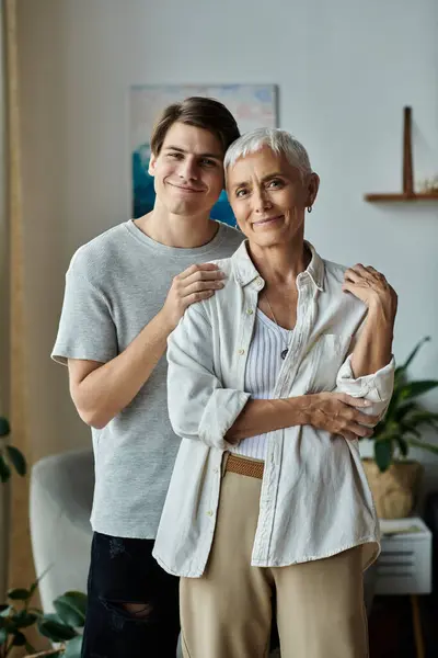 stock image A joyful mother and son share a heartfelt embrace, celebrating their bond in a cozy living room.