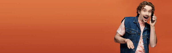 A joyful man engages in a lively phone conversation, showcasing vibrant emotions.