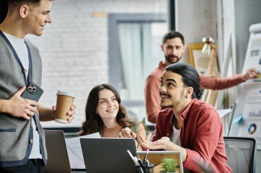 Colleagues converse, sharing thoughts in a stylish office. clipart