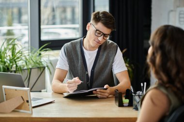 Colleagues dressed in elegant casual attire discuss challenging layoff news. clipart