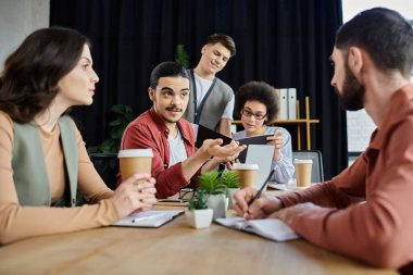 Team members discuss challenges during a restructuring meeting. clipart