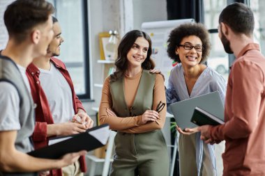 Colleagues engage in animated conversations amid a challenging layoff process.