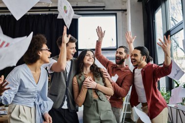 Team of colleagues joyfully shares moments in office.