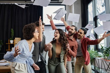 Excited colleagues share a moment of joy. clipart