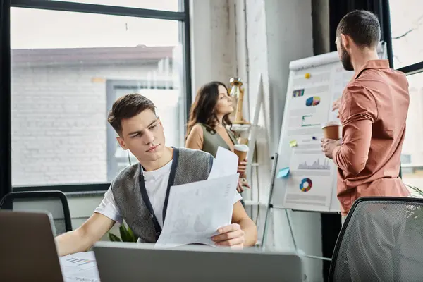 stock image Team members share thoughts and documents in a contemporary work environment.