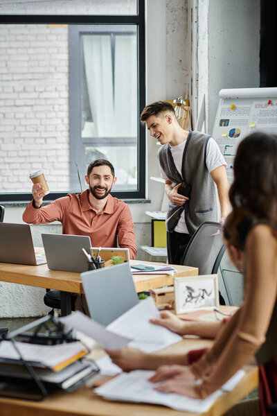 Colleagues share smiles and ideas during a discussion.