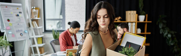 Woman gracefully manages departure amid a corporate transition, colleagues on backdrop.