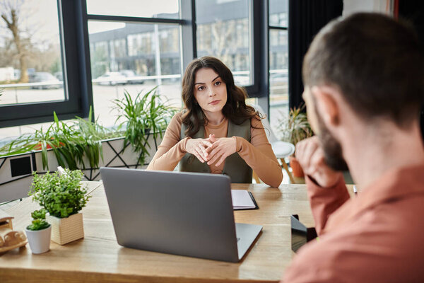 Colleagues engage in a serious discussion during the layoff process.