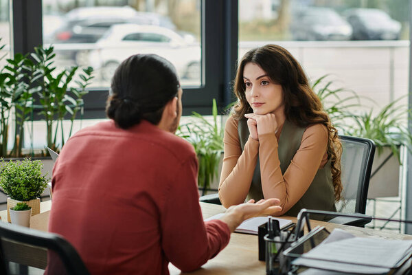 Two colleagues converse thoughtfully amid a challenging layoff situation.