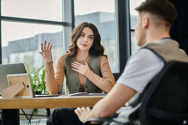 Colleagues converse thoughtfully amidst a challenging layoff discussion.