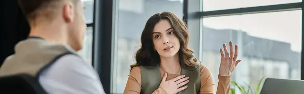 stock image Good looking colleagues discuss feelings during the layoff process in a contemporary workspace.