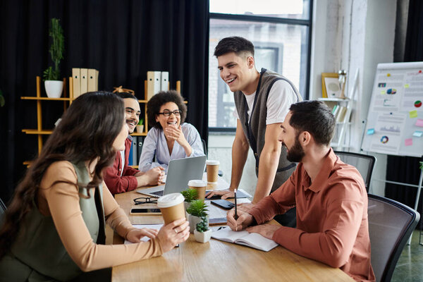 Colleagues share lighthearted moments amid their work.