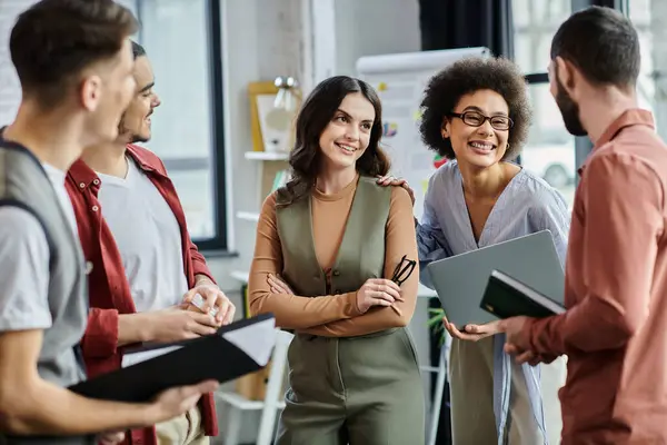 stock image Colleagues engage in animated conversations amid a challenging layoff process.