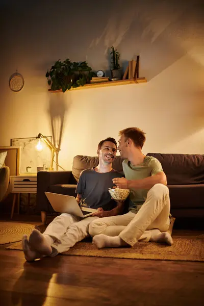 stock image Two men share joyful moments together on a cozy evening.