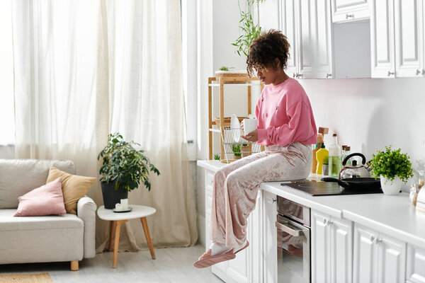 Relaxing at home, savoring a warm drink in a stylish kitchen.
