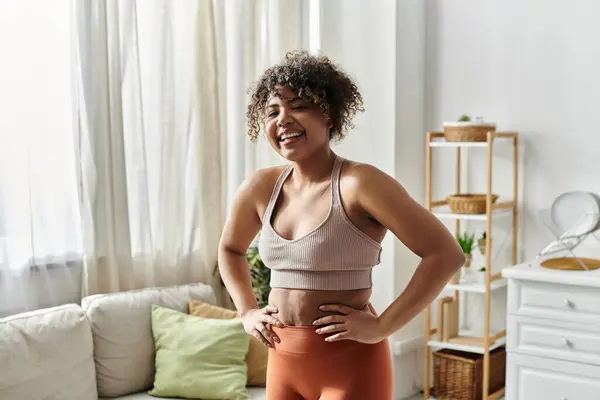 stock image A cheerful woman promotes wellness and positivity in her cozy living space.