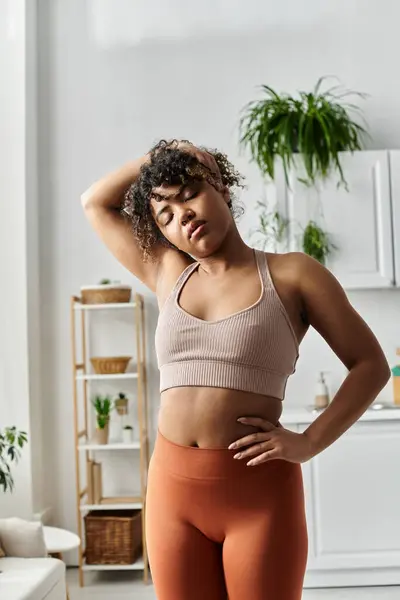 stock image A young woman practices self care while enjoying her cozy home.