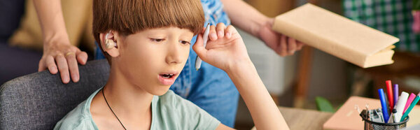 A loving mother engages with her hearing impaired son during a playful afternoon.