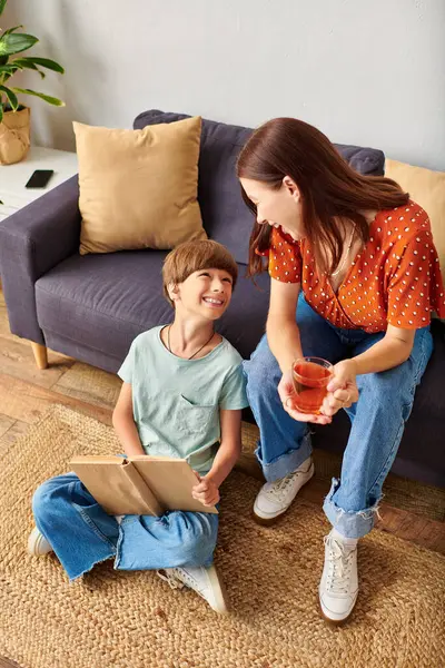 stock image A mother shares a joyful moment with her hearing impaired son while they relax together.