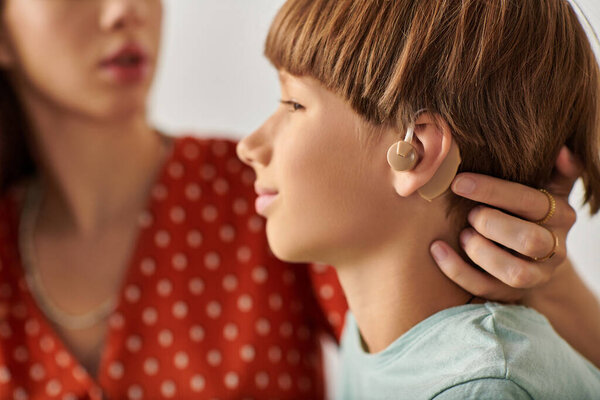 Mother and son share a tender moment, focusing on communication and connection.