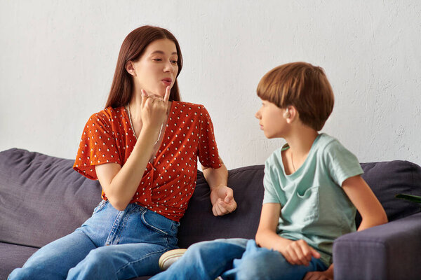 A caring mother and her hearing impaired son engage in joyful communication.