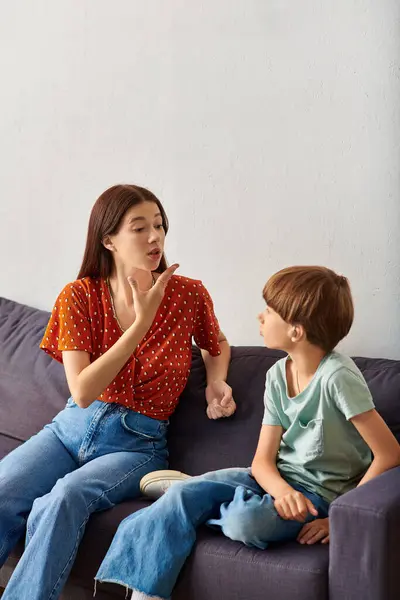 stock image A mother engages with her hearing impaired son using sign language.