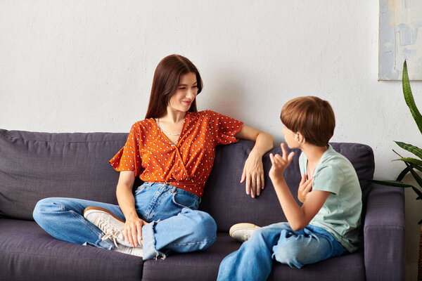 A mother and her son enjoy a heartfelt conversation using sign language.