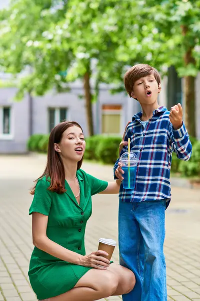 stock image A mother and her son share a special bonding moment outdoors, filled with laughter.