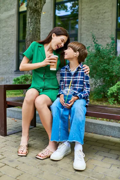 stock image A mother shares a special moment with her hearing impaired son while seated.