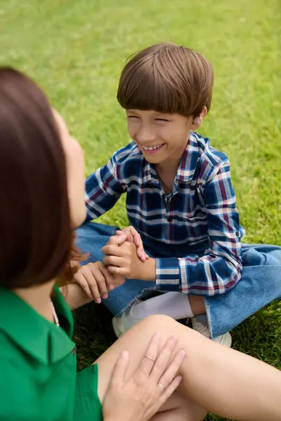 stock image A mother shares laughter with her hearing impaired son, both enjoying their time together.