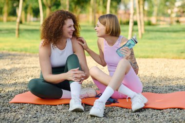 Bir çift yoga minderlerinde otururken birbirlerine eşlik etmekten zevk alırlar.