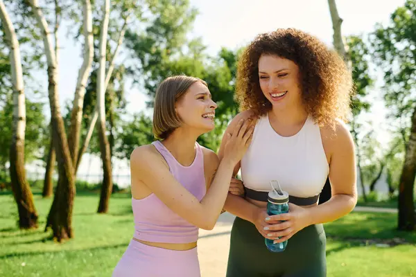 stock image Two women share laughter and connection while relaxing outdoors.