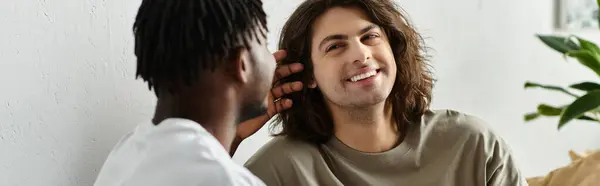 stock image Two partners share laughter and affection while enjoying their cozy home environment.