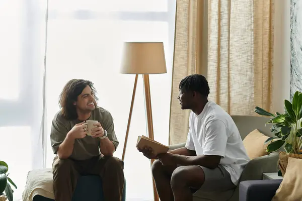 stock image Two partners share laughter and love while sipping drinks in their welcoming living room.