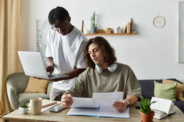 stock image A devoted couple engages in meaningful work together, sharing laughter and support at home.