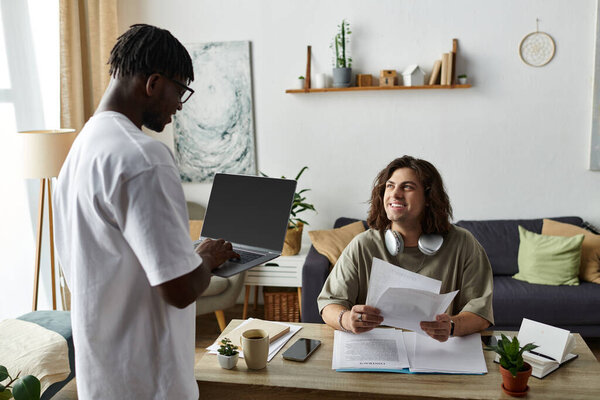 Two partners share a cozy moment at home, engaging in work while connecting and smiling.