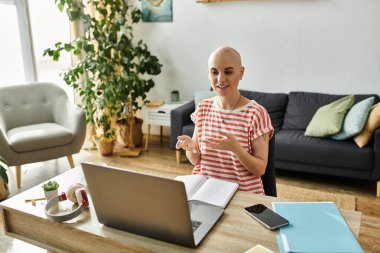 A vibrant bald woman with alopecia shares ideas while sitting at her desk, enriching the atmosphere. clipart