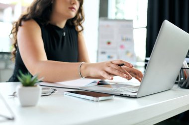 A young, plus-size professional with curly hair focuses on her tasks, actively collaborating at her modern office space. clipart