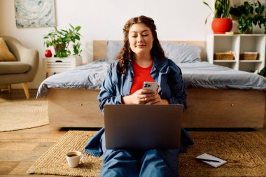 Relaxing at home, a young, beautiful woman engages with her laptop while enjoying a warm cup of coffee. clipart