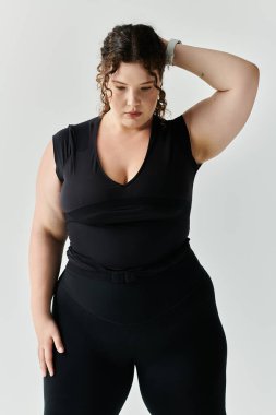 An elegant plus size woman with curly hair poses beautifully in a sleek black outfit. clipart