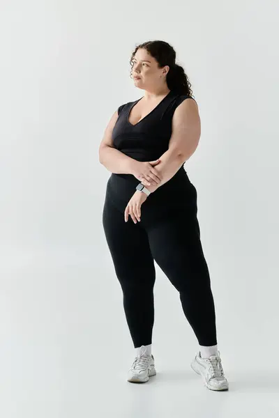 stock image An elegant and beautiful plus size woman stands tall, showcasing her style and confidence.