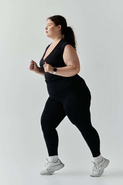 A confident plus size woman jogs with elegance, showcasing her active lifestyle in stylish attire.