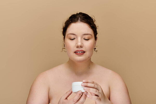 A graceful plus size woman applies cream, embracing self care in a serene environment.