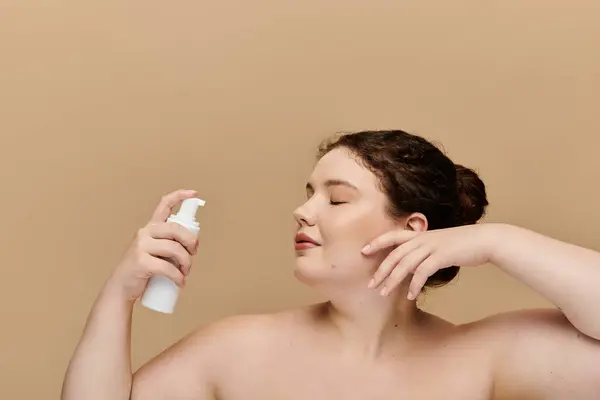 stock image A confident woman enjoys a moment of self care while applying moisturizer, radiating beauty.