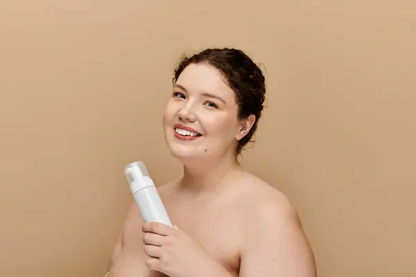 stock image The graceful woman joyfully showcases her skincare routine while smiling charmingly.