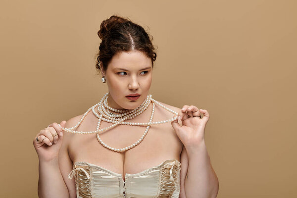 A stunning plus size woman wears pearls and exudes elegance in a minimalist backdrop.