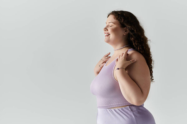 An elegant plus size woman embraces her beauty with joy and confidence, showcasing self love.