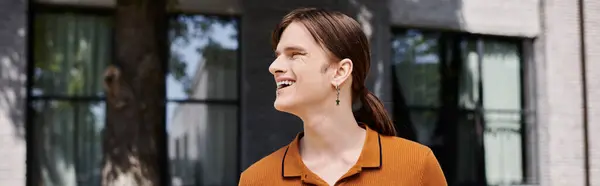 stock image A joyful non binary person stands outdoors, soaking up the sun during a break at the office.