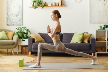 İştahsız genç bir kadın yoga yapıyor. Sakinleştirici yaşam alanında gücünü ve dayanıklılığını gösteriyor..